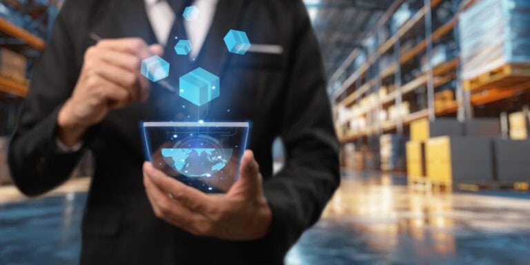 Digital inventory management with holographic data visualization in a warehouse environment.