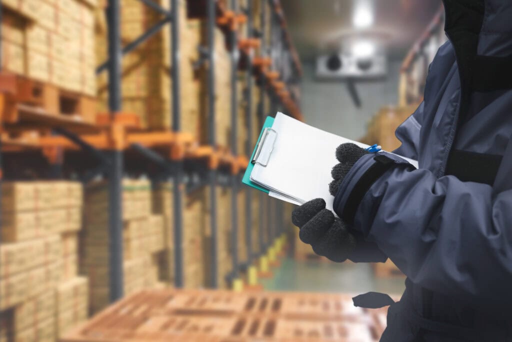Warehouse inventory management with clipboard and barcode scanner.