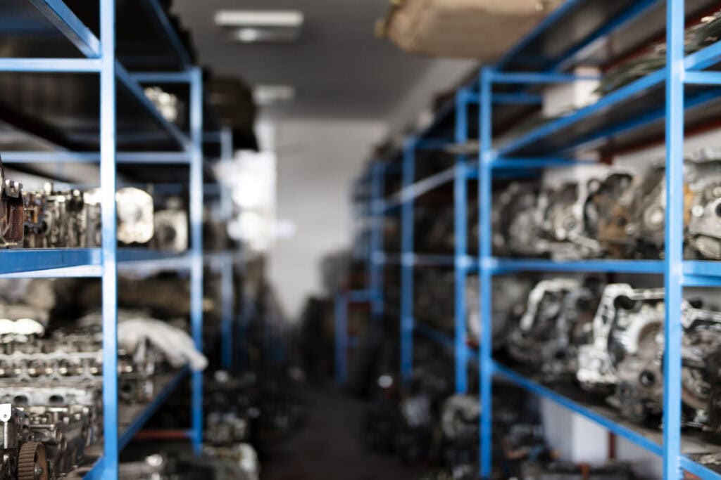 Industrial storage shelves with engine parts in a warehouse.