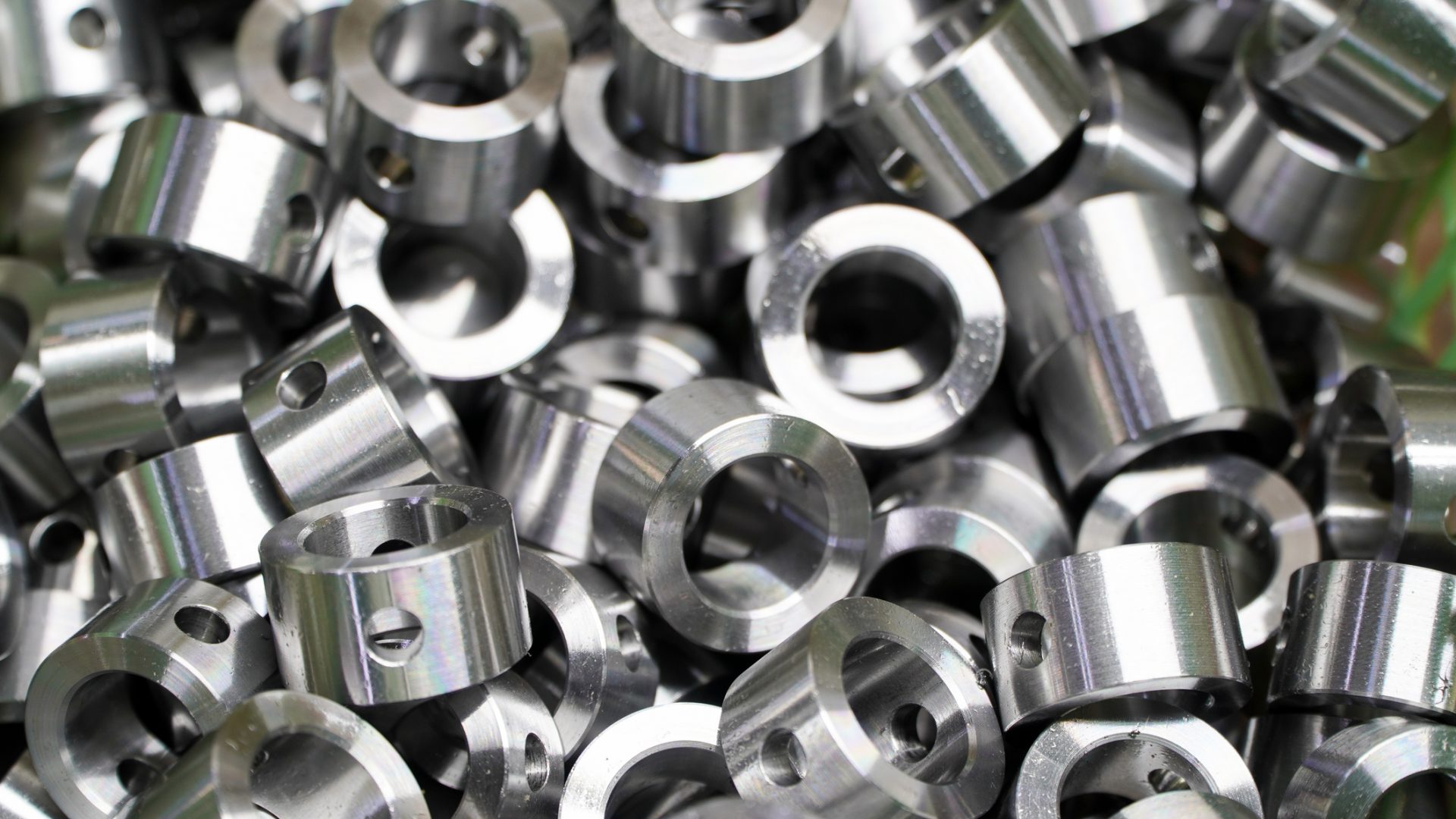 Shiny steel parts background. Regular industrial metal production pattern with selective focus.High precision steel automotive parts manufacturing by innovative CNC machining