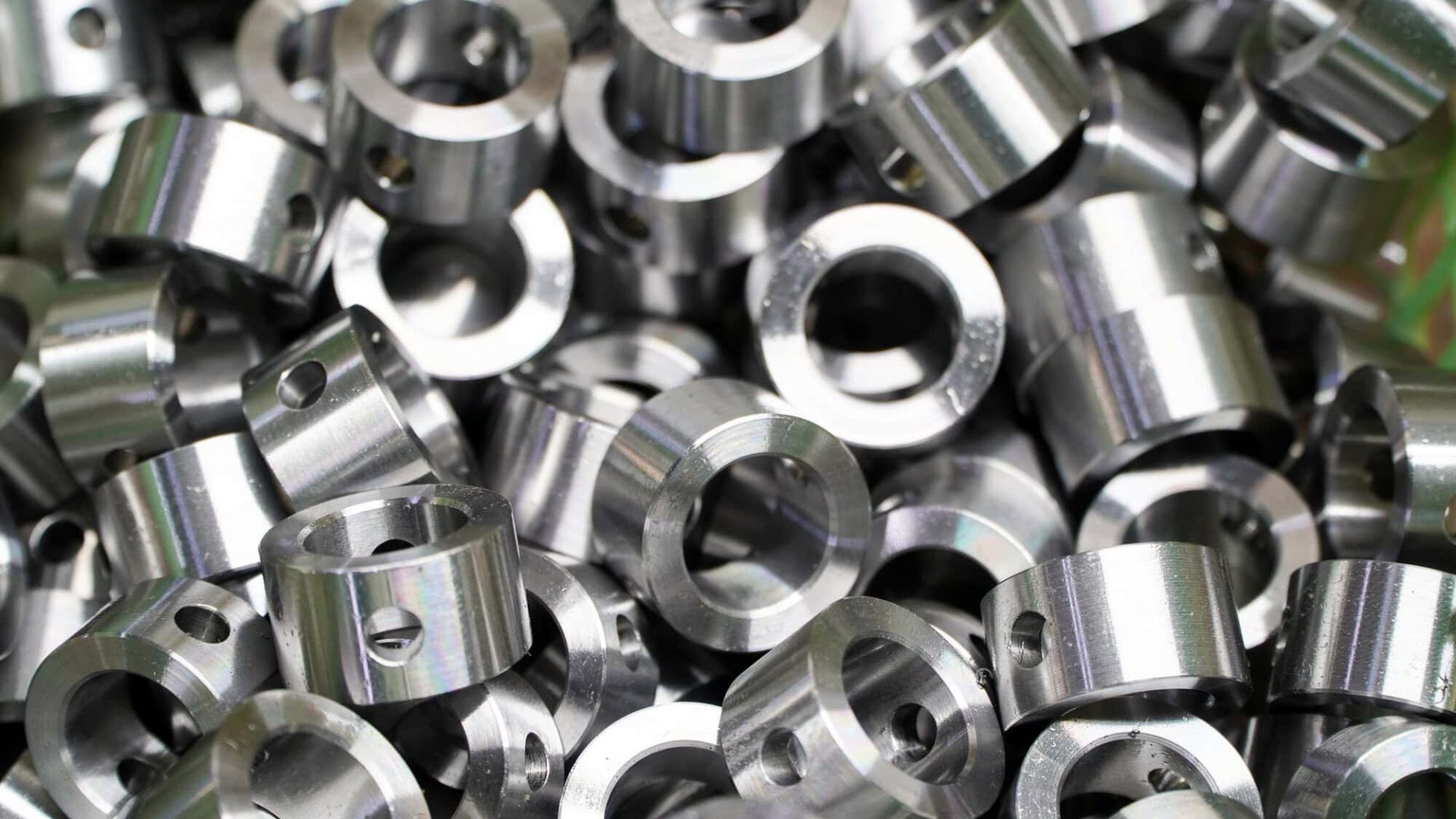Shiny steel parts background. Regular industrial metal production pattern with selective focus.High precision steel automotive parts manufacturing by innovative CNC machining