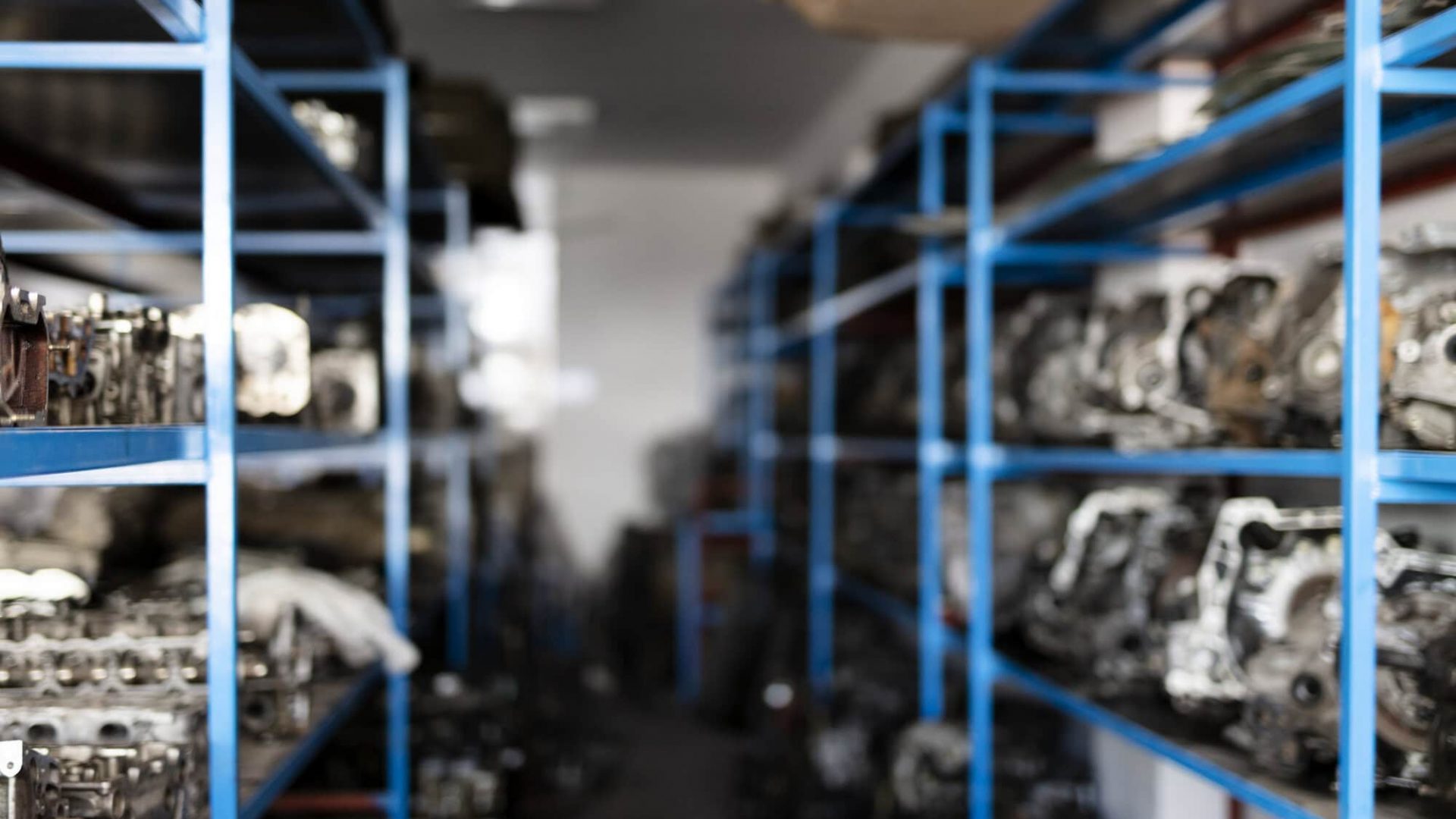 Industrial storage shelves with engine parts in a warehouse.