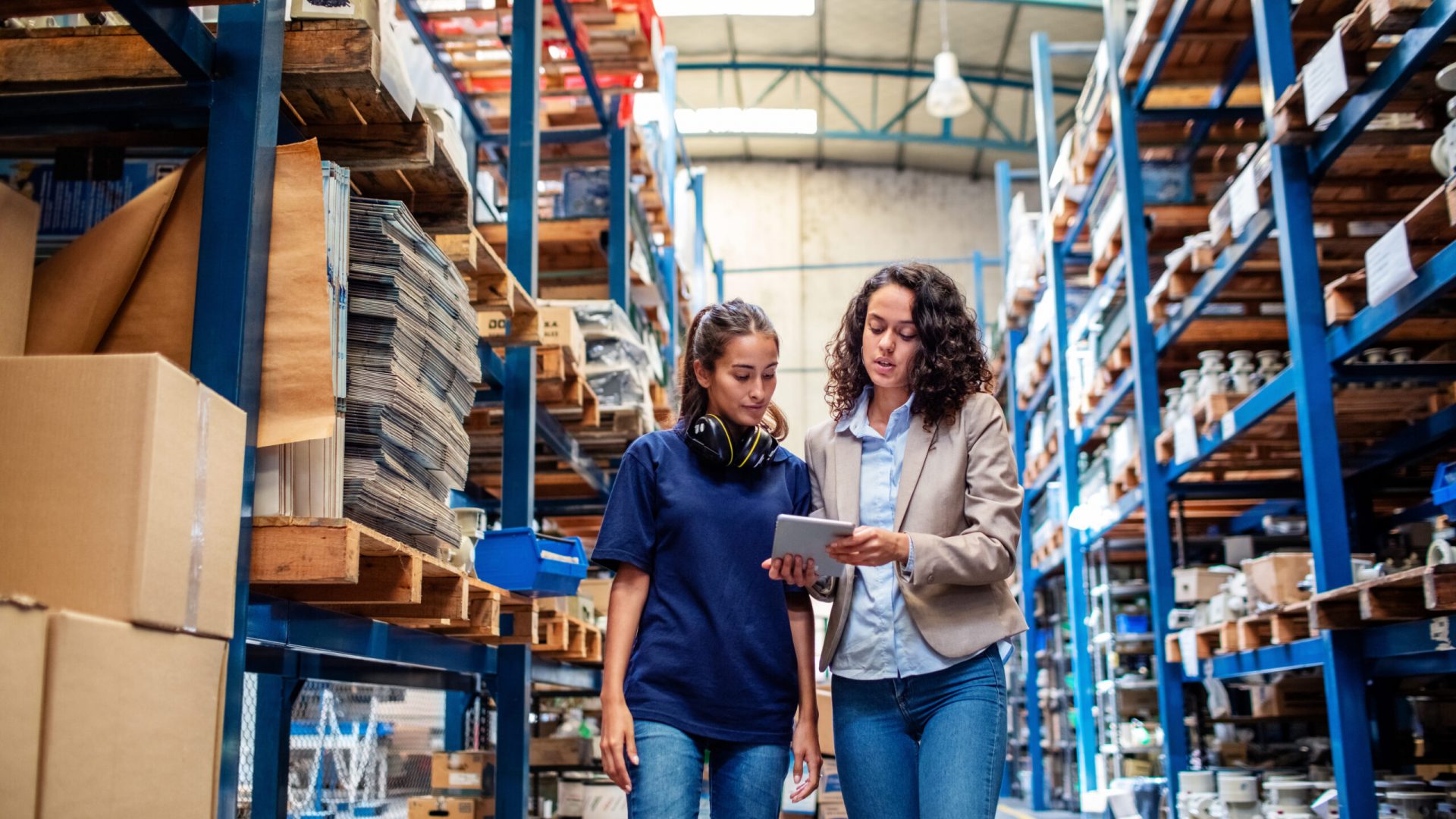 Two women working in company warehouse Tail spend